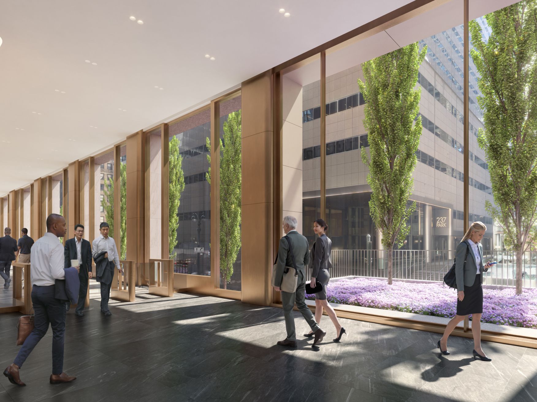 A double-height, light-flooded lobby looking out onto lush, new landscaping